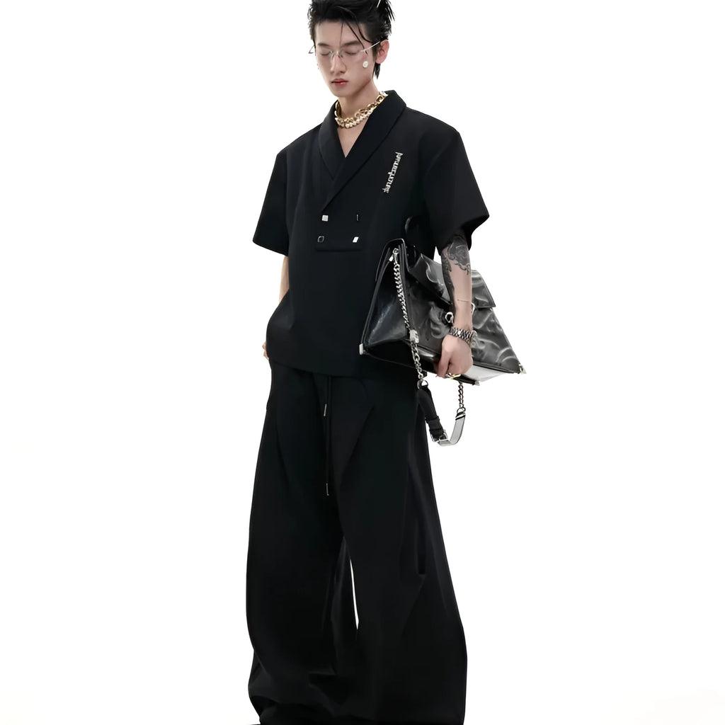 Men's dark grey V-neck sports jacket with padded shoulders and matching shorts