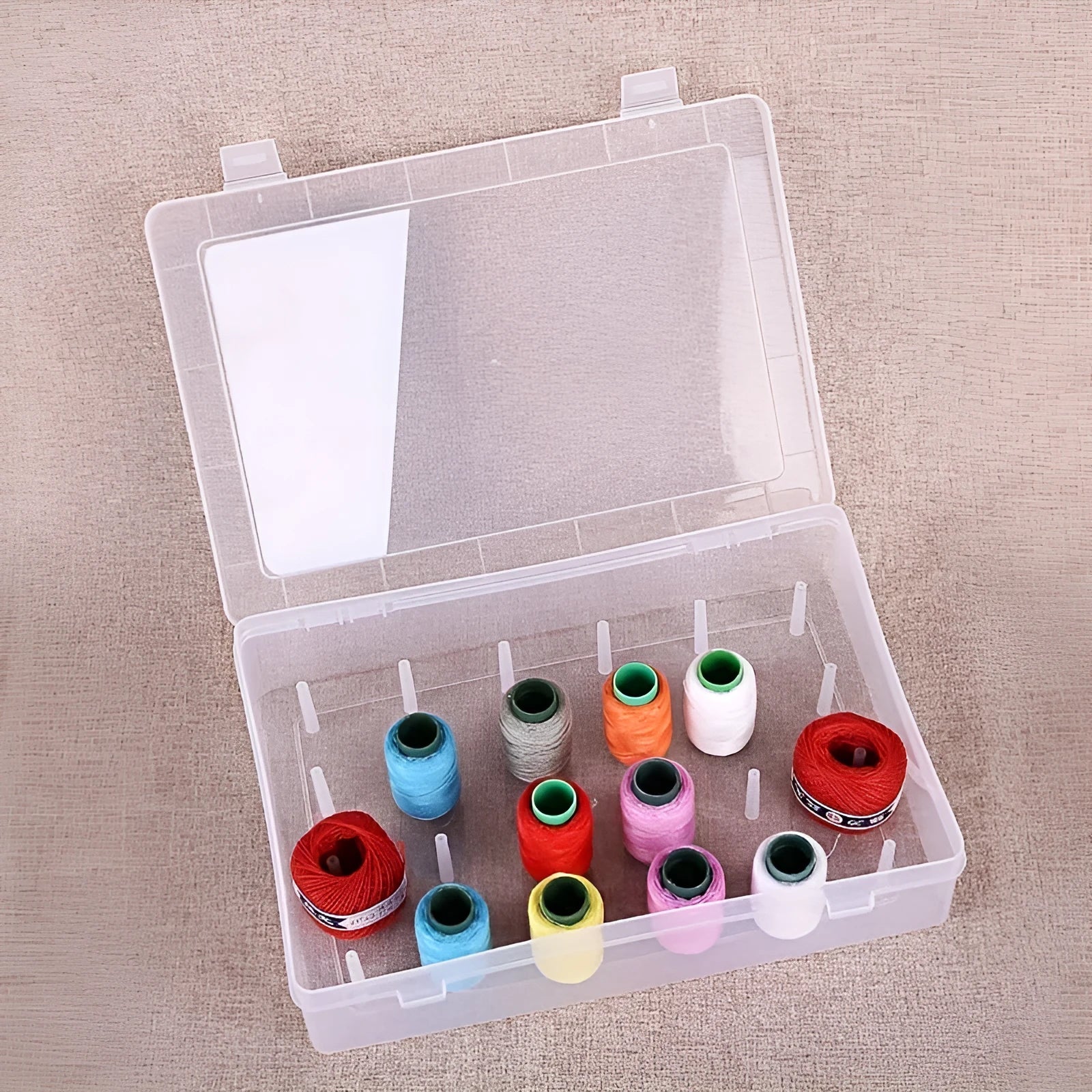 Transparent plastic storage box with 42 small compartments for organising sewing threads and embroidery floss.