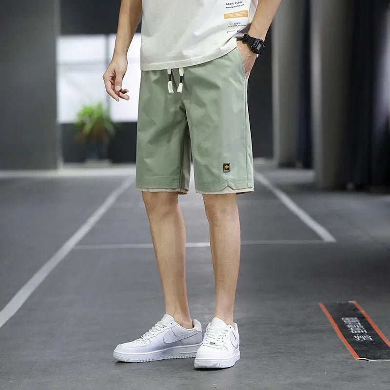 Men's loose-fit straight-leg casual beach shorts in polyester, shown in 8905 Green colour.