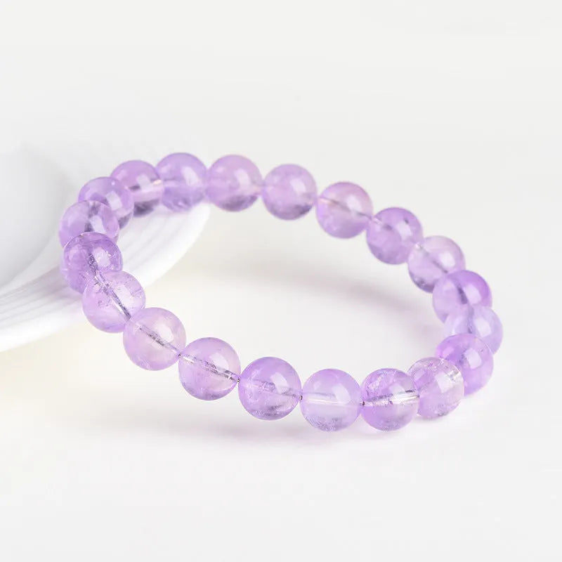 Lavender round amethyst bead bracelet with water ripple design on a cream body and transparent lavender beads.