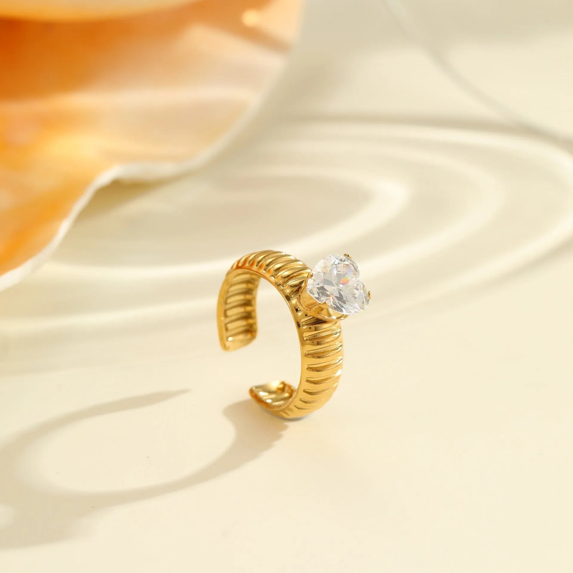 Open mouth geometric stainless steel ring with heart drop shape and gold inlaid zircon.