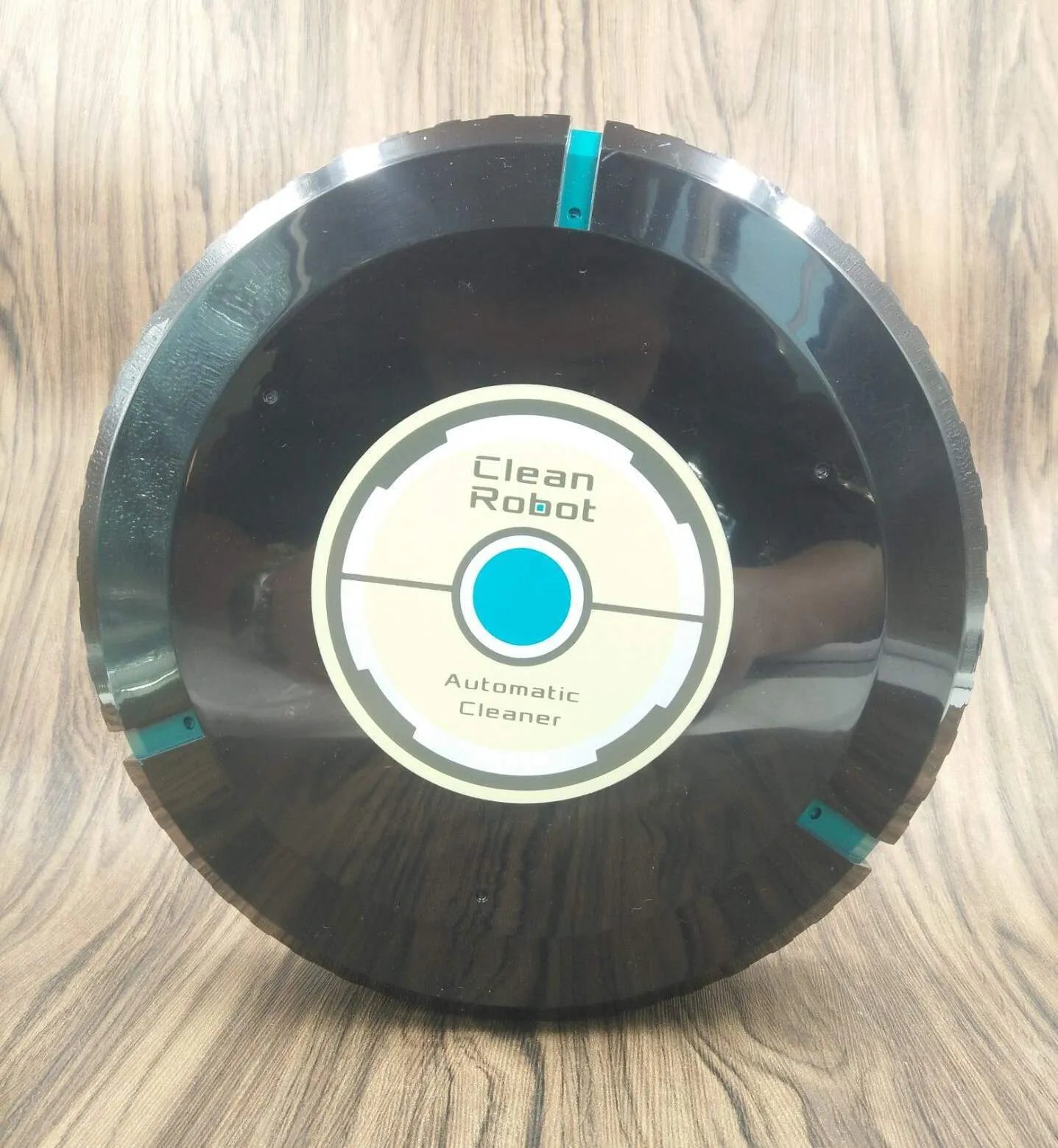 Black or pure white automatic floor sweeping robot with 23cm diameter on wooden floor