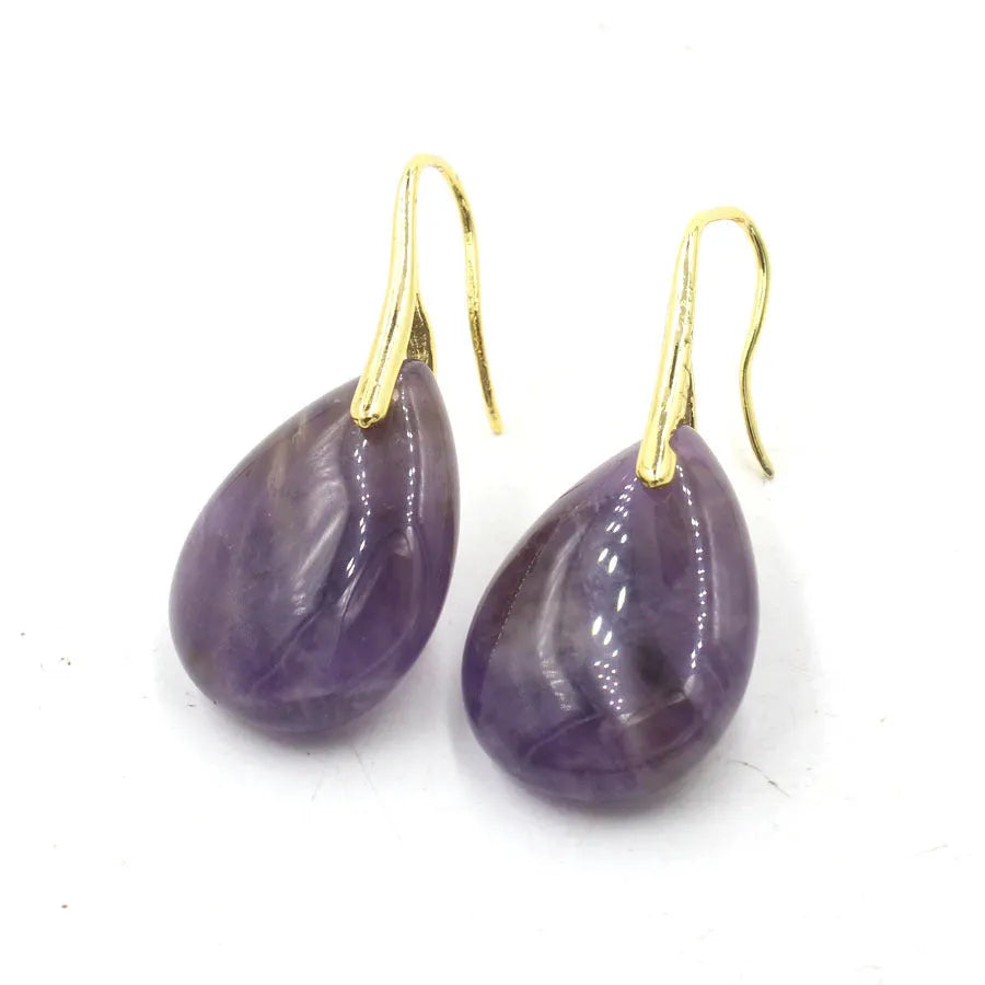A pair of geometric water drop earrings made from crystal in one of nine colours, with an electroplated metal setting.