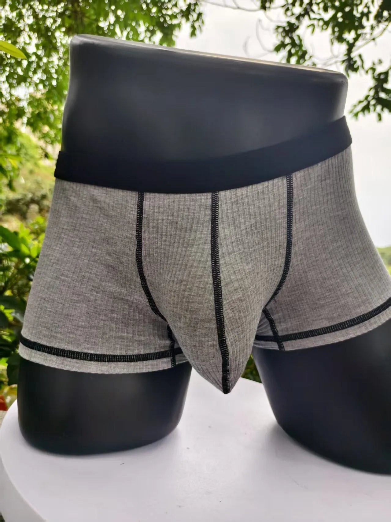 Men's solid colour boxer shorts on a white background, showing thin breathable fabric.
