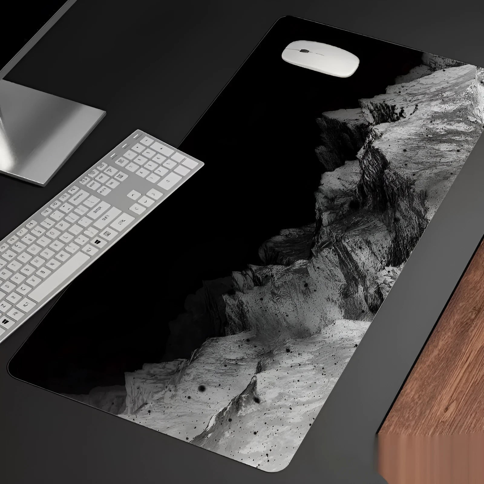 Oversized gaming mouse pad with printed design showing multiple size options and integrated wrist rest