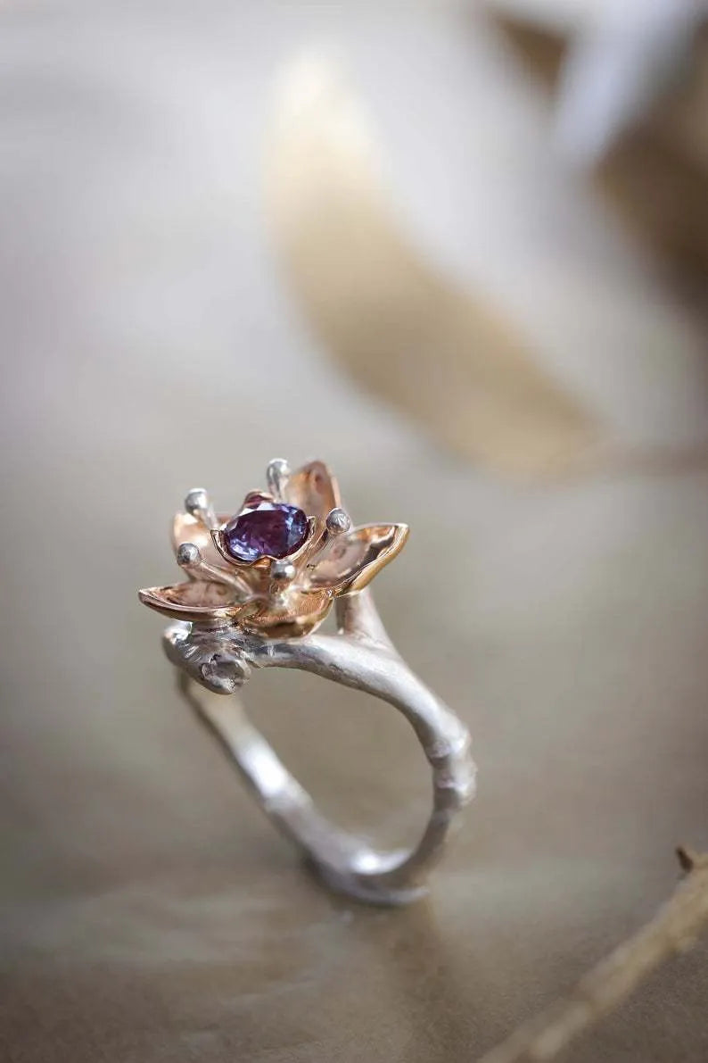 Silver two-tone floral geometric women's alloy ring shown on a finger.