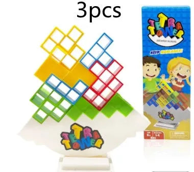 Plastic balance stacking game with 16 coloured building blocks, chassis, and base on a table