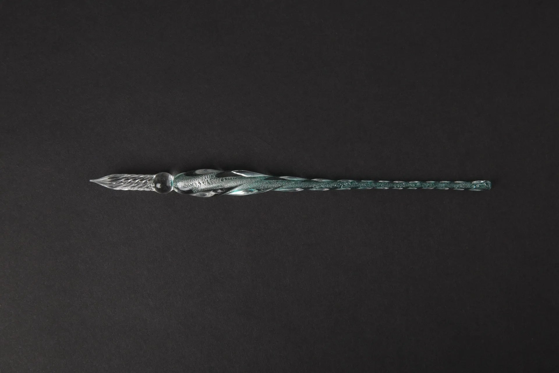 Transparent glass signature pen with coloured ink visible inside, abstract modelling, gift box packaging