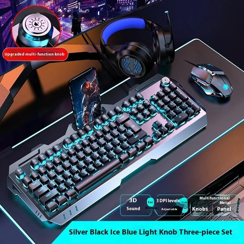 Aluminium gaming keyboard with volume knob, shown in metal grey with RGB lighting alongside optional macro mouse and headset.