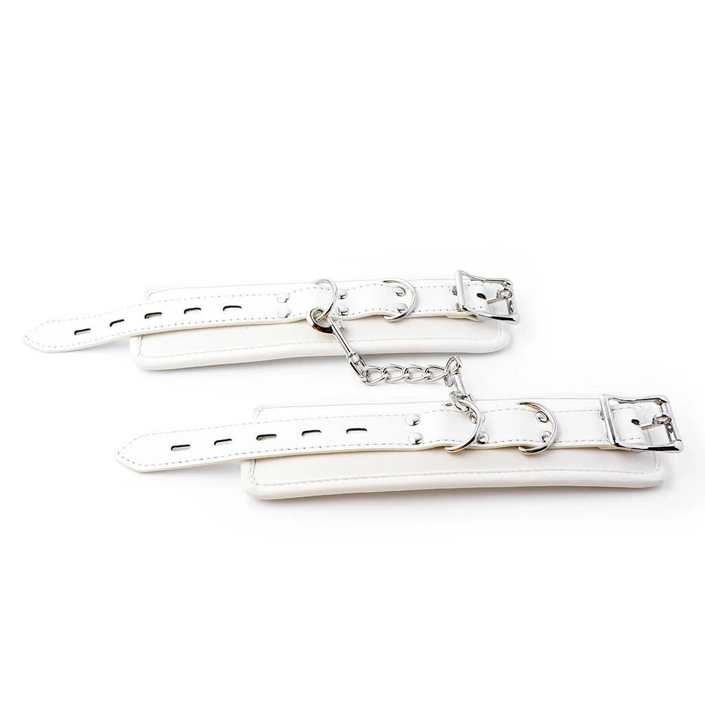 White PU sponge bondage set showing handcuffs, foot cuffs, and neck cuff for adult restraint