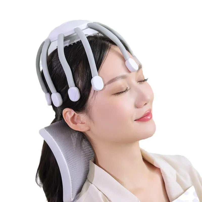Black USB-powered head massager with multiple claws placed on a scalp