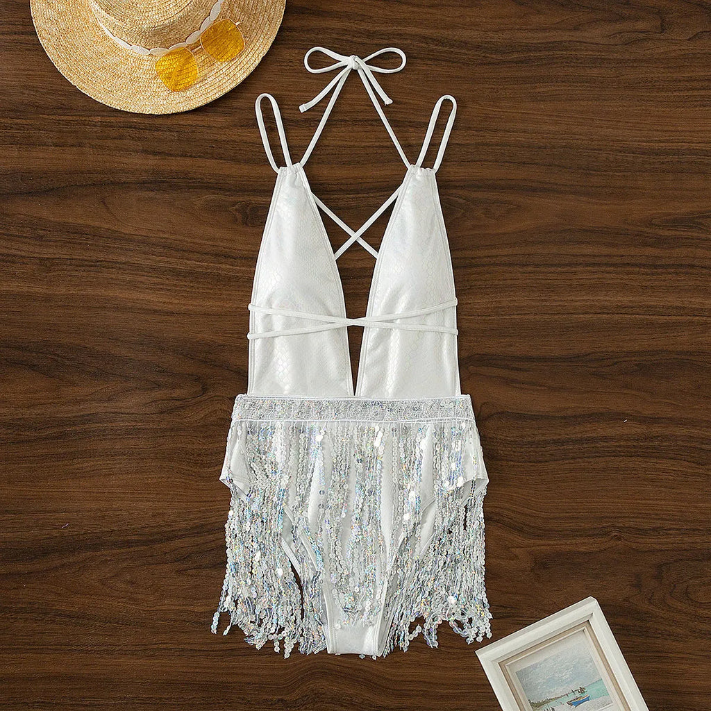 White women's one-piece swimsuit with deep V-neck and decorative tassels.