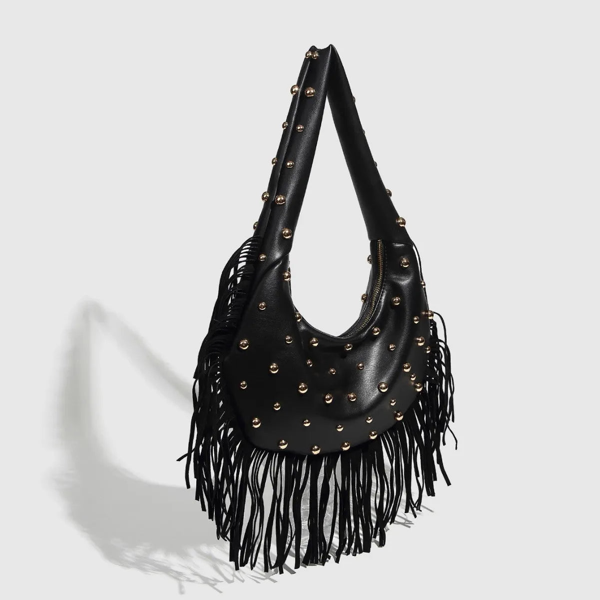 Retro black shoulder handbag with a long tassel decoration and an internal phone pocket.