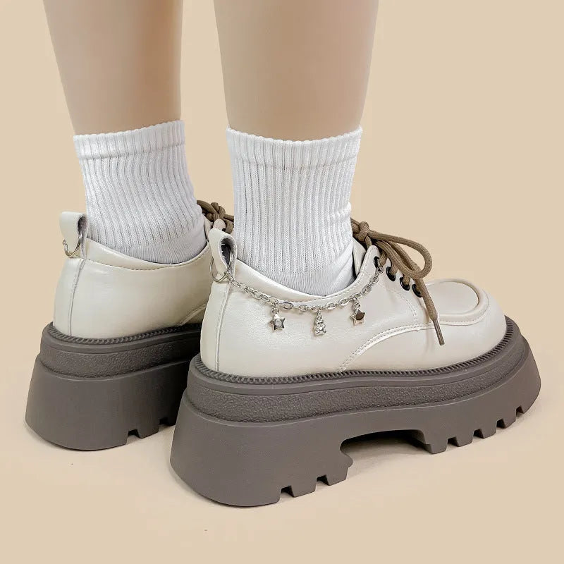 White Amy And Mai PU leather Mary Jane platform shoes with chunky heel and lace-up front.