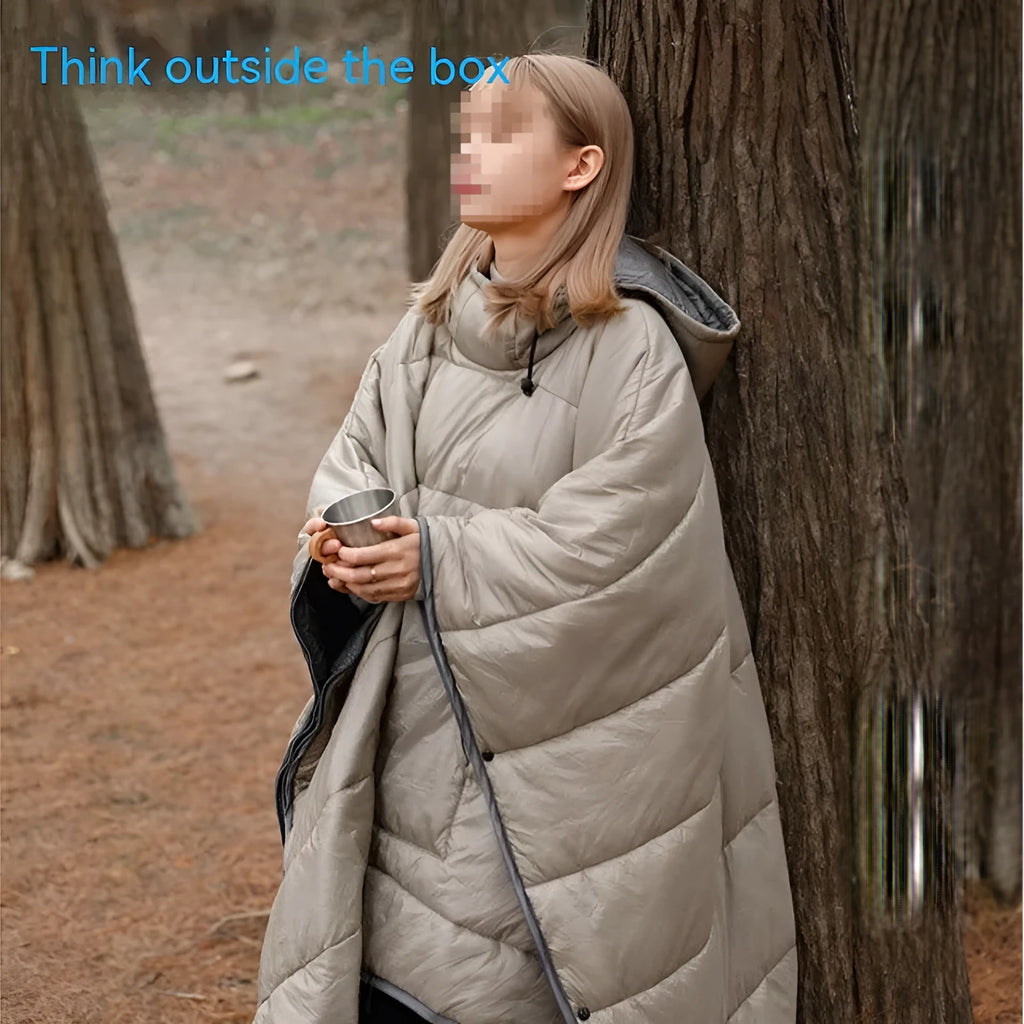 Grey adult-sized outdoor cloak sleeping bag worn as a cape, showing its 200x140cm dimensions.