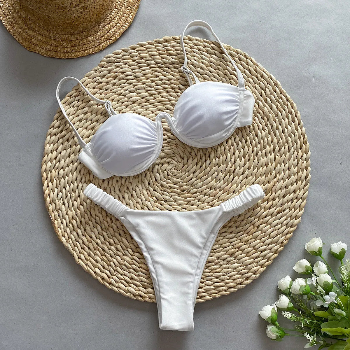 Women's black underwire bikini swimsuit set with split briefs on a neutral background.