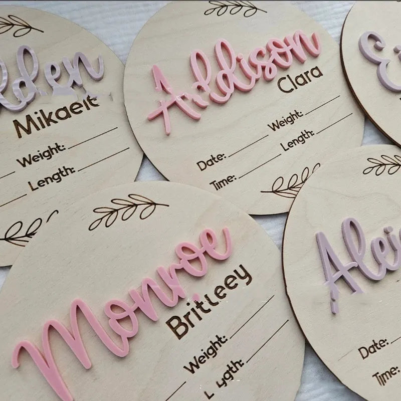Square 15cm wooden baby name plaque with birth details displayed, shown in three style options.
