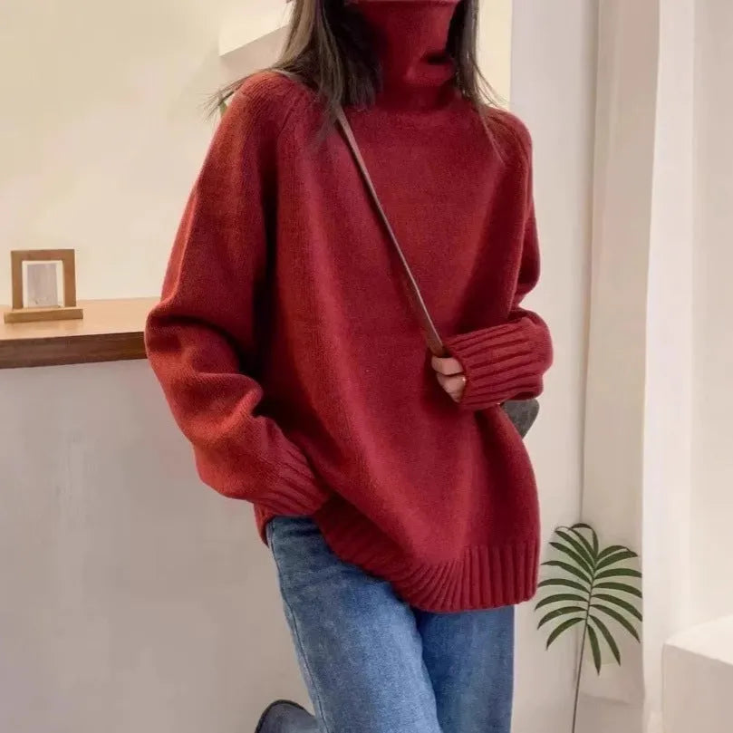Red women's loose turtleneck sweater with a thick, textured curling pile collar.