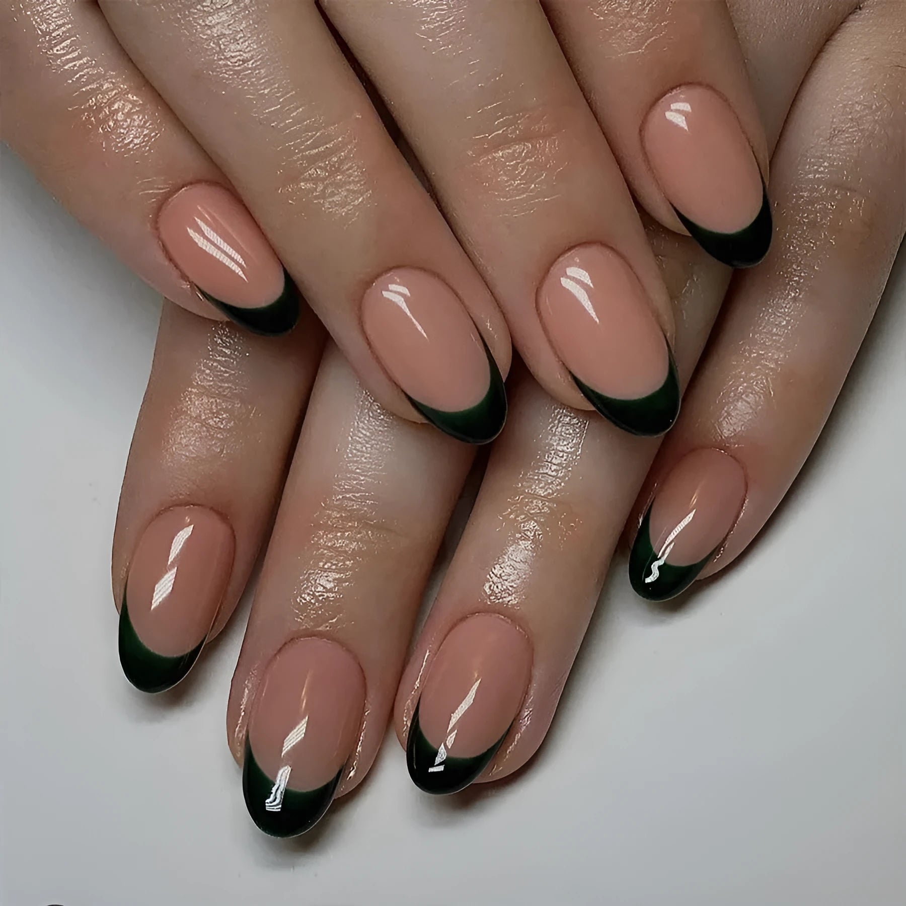 Pack of 24 black French style artificial nails with a short almond shape.