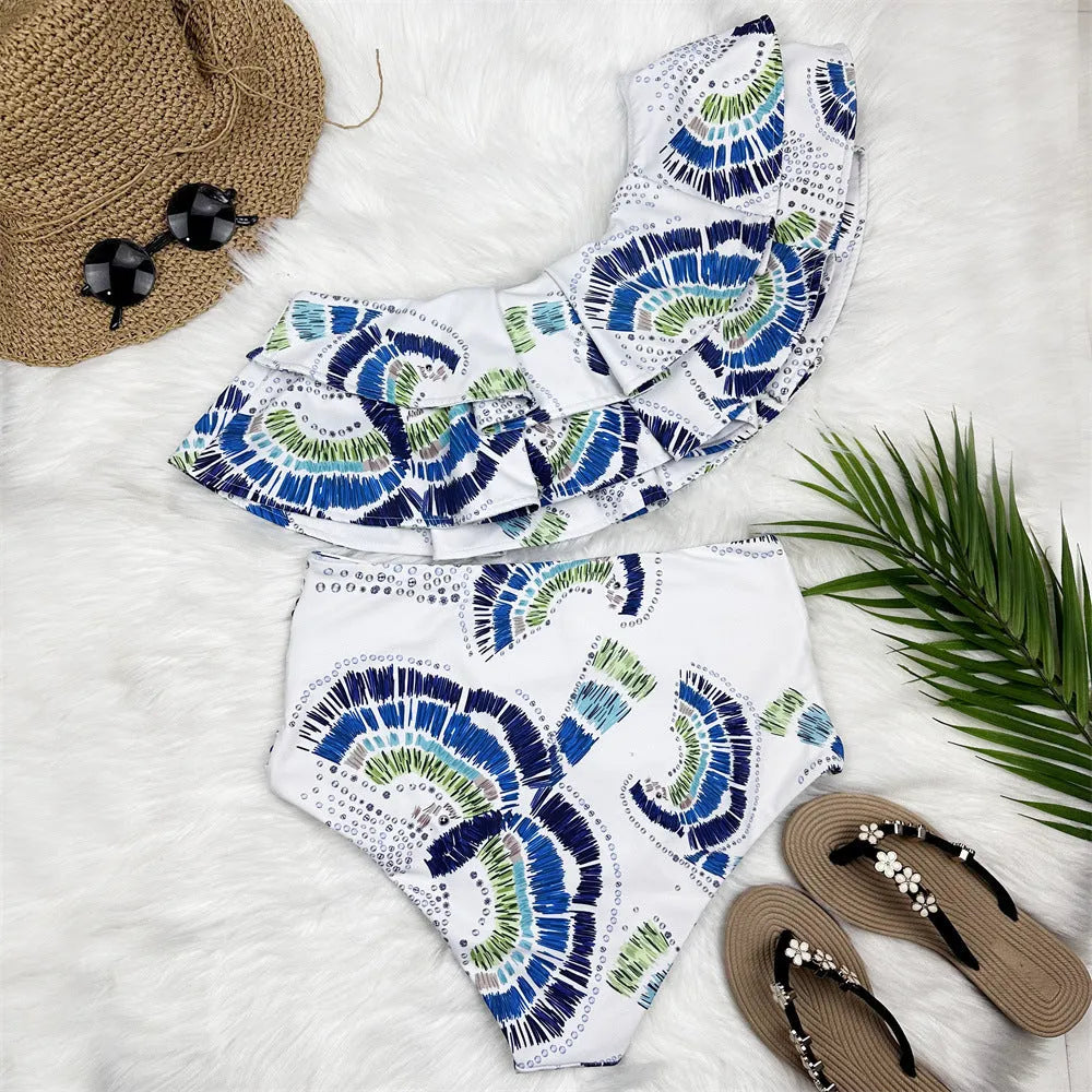 White women's one-shoulder swimsuit with large lotus leaf detail and side split.