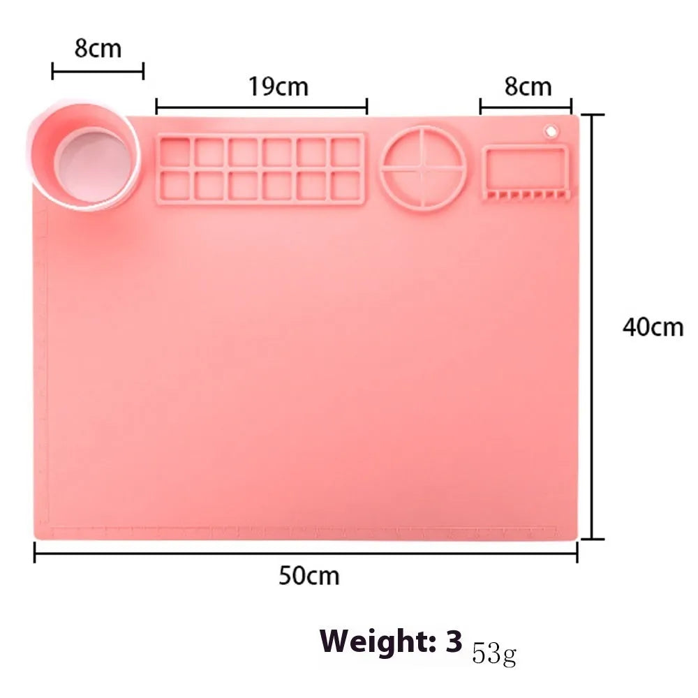 Green silicone painting mat measuring 50 by 40 centimetres with two round bowl wells for holding water or paint.