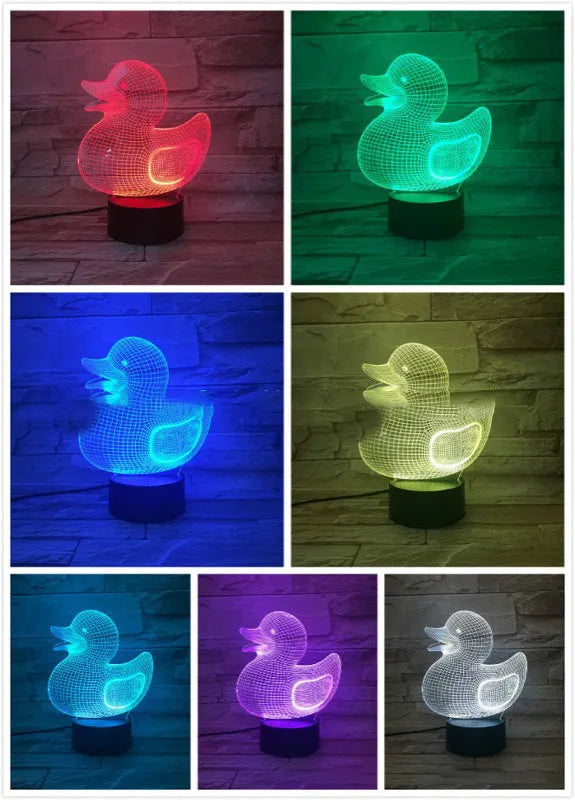 Little Yellow Duck 3D night light showing seven LED colours on a tabletop with remote control.