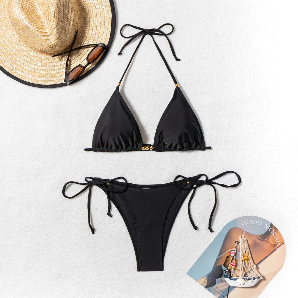 Black women's bikini swimsuit with metal bead decorative details on two-piece set