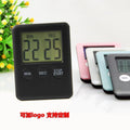 Digital kitchen timer with magnetic back showing LCD countdown display on refrigerator