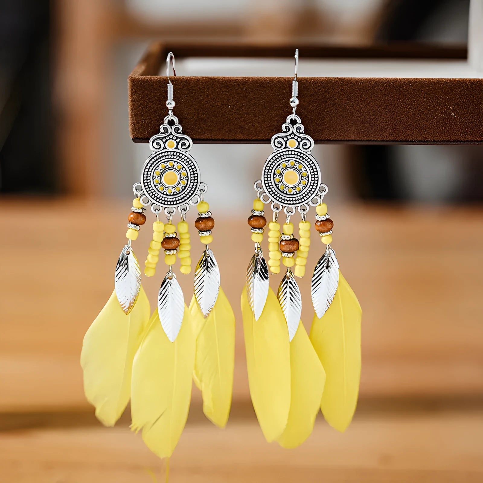 Round drop feather earrings with leaf detailing in various bohemian colours