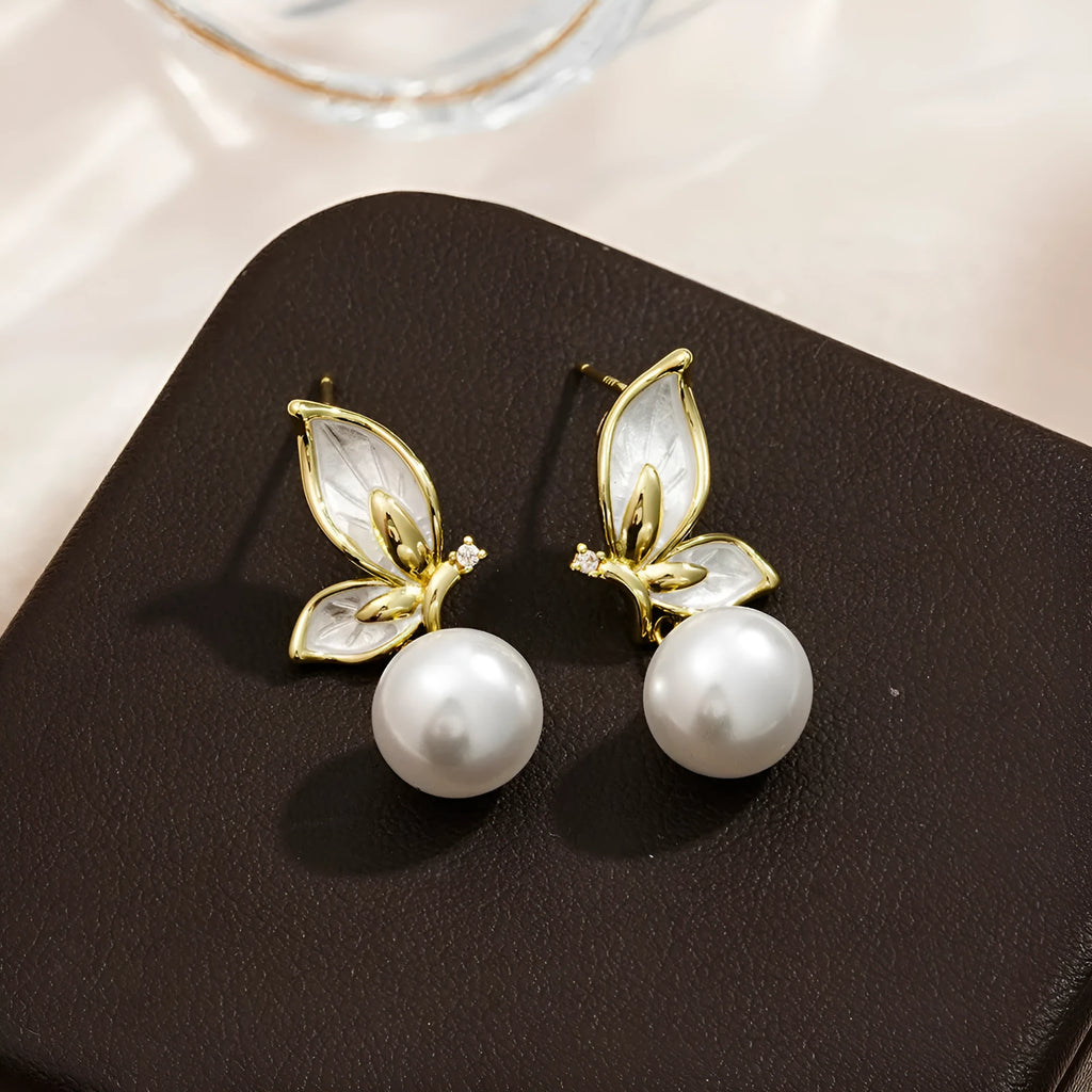 Pair of simple style butterfly earrings for women with electroplated copper construction.