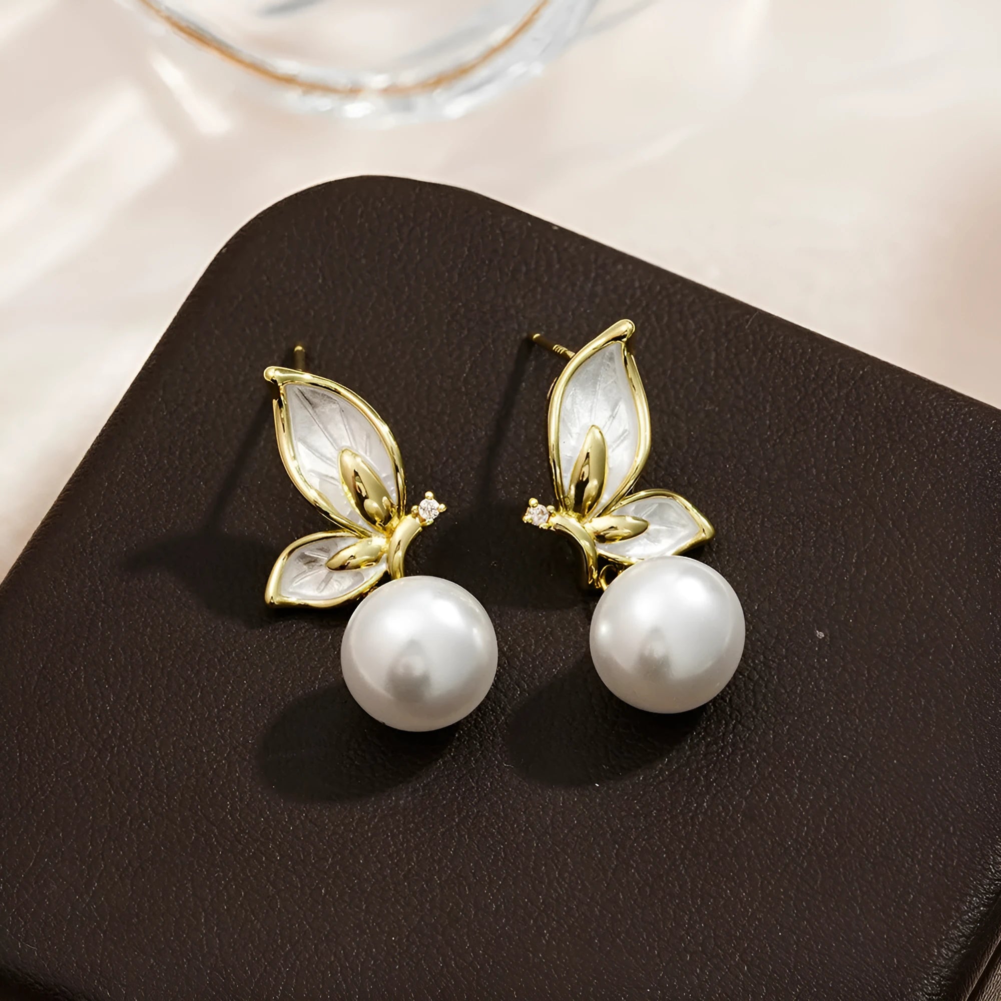 Pair of simple style butterfly earrings for women with electroplated copper construction.