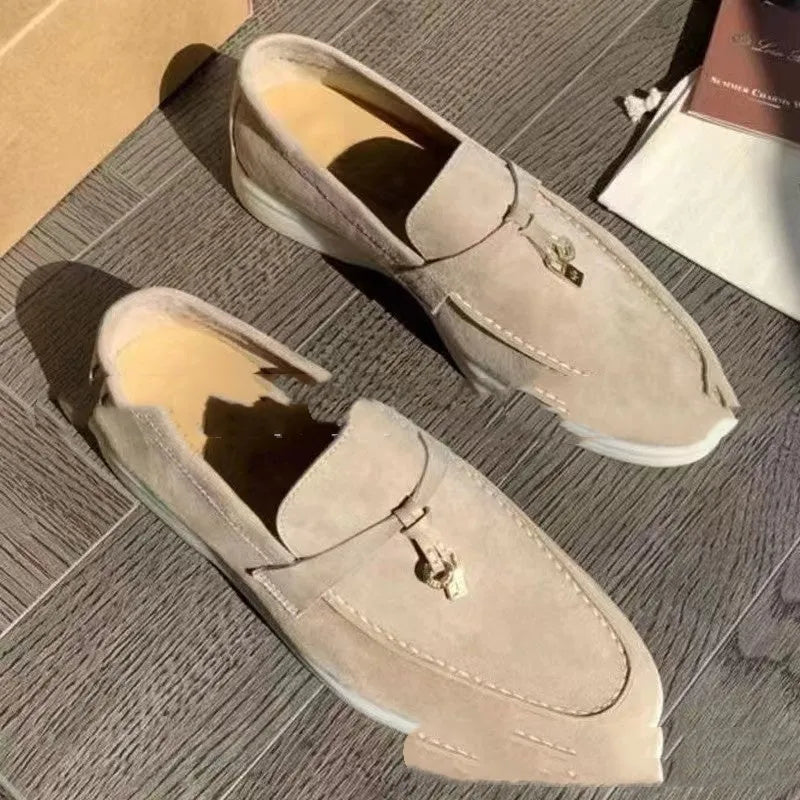 Unisex high-top slip-on loafers with a round toe cap and rubber sole on a neutral background.