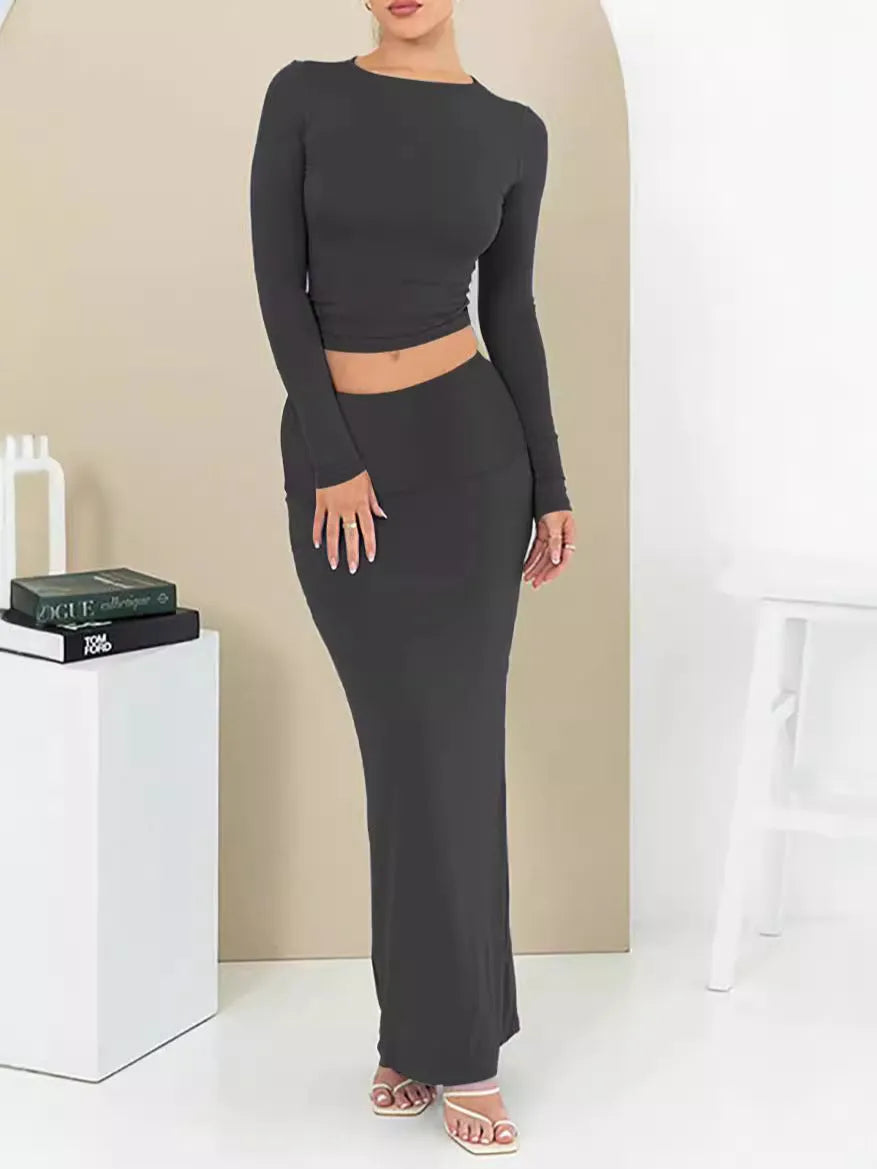 Women's black slim fit polyester two-piece suit with three-quarter sleeve top and long skirt.