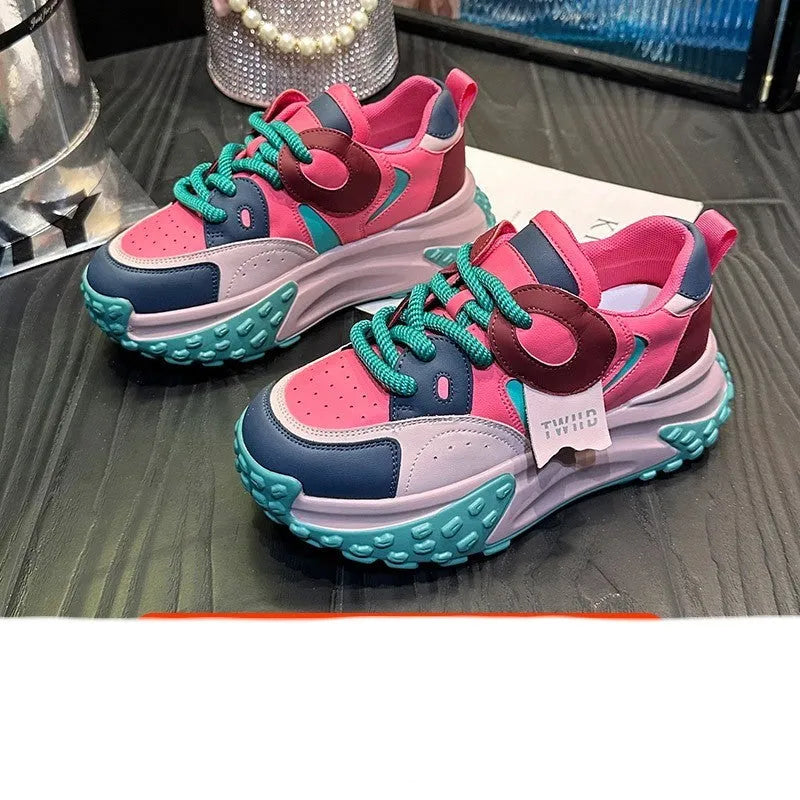 A pair of thick-soled leather casual shoes with a wedge heel and round toe in a lace-up design.