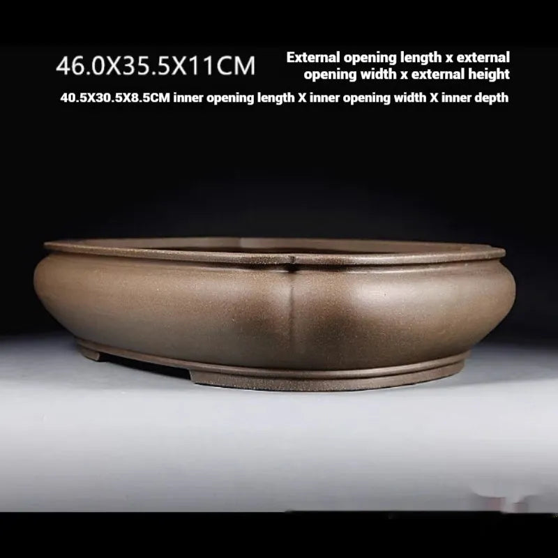 Handmade antique purple clay papaya-shaped flower pot on a wooden surface.