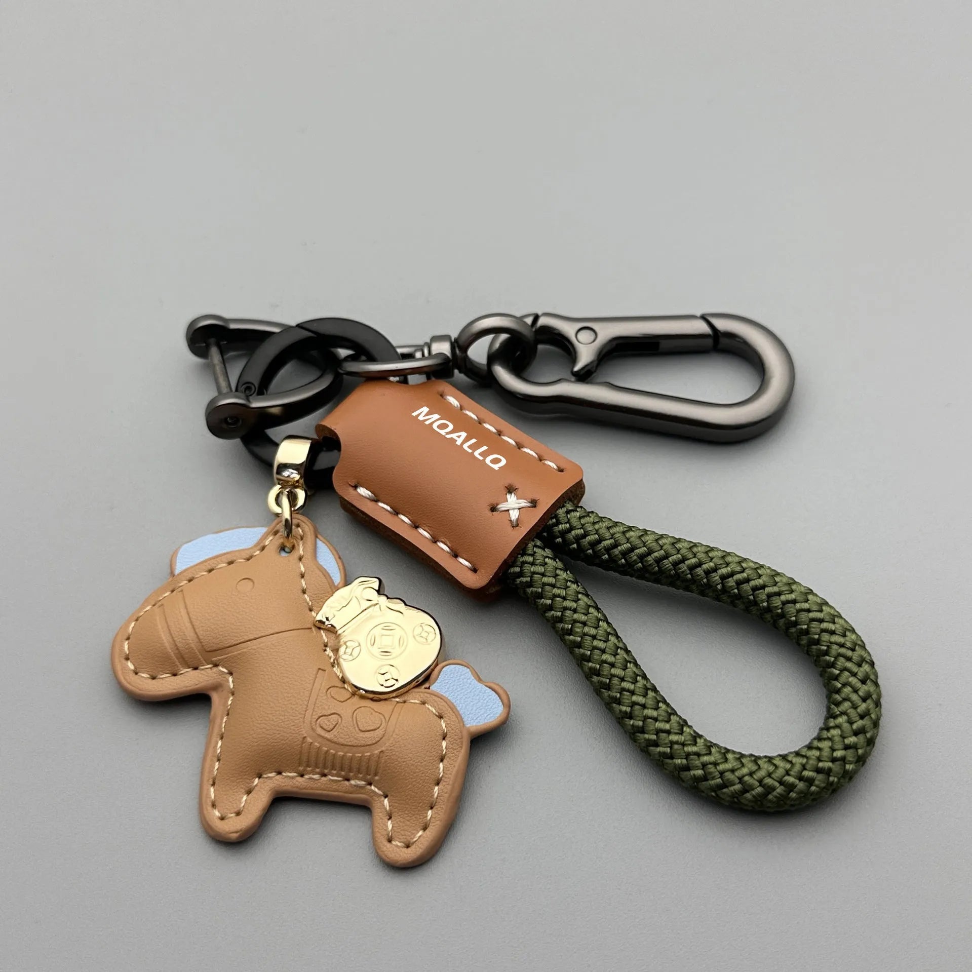 Handmade brown cowhide car key pendant with green flanelle rope and a metal buckle.