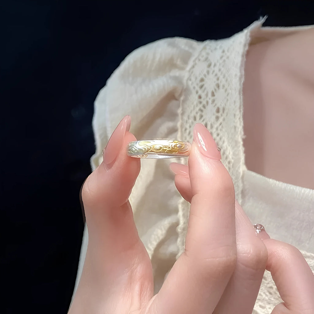 Geometric xiangyun pattern open mouth ring in silver electroplated finish on white copper.