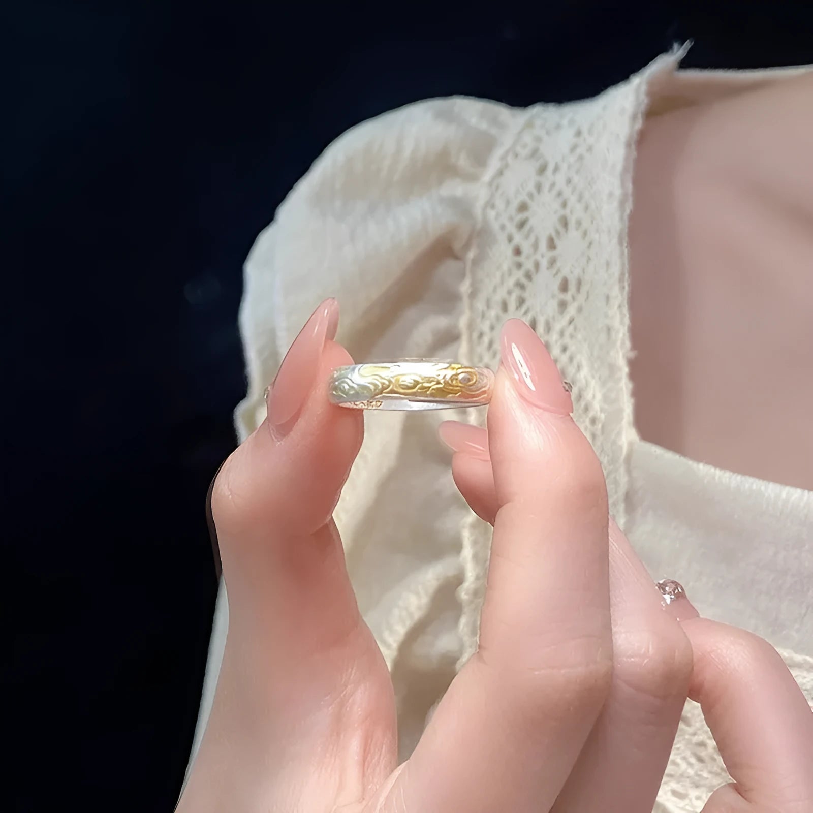 Geometric xiangyun pattern open mouth ring in silver electroplated finish on white copper.
