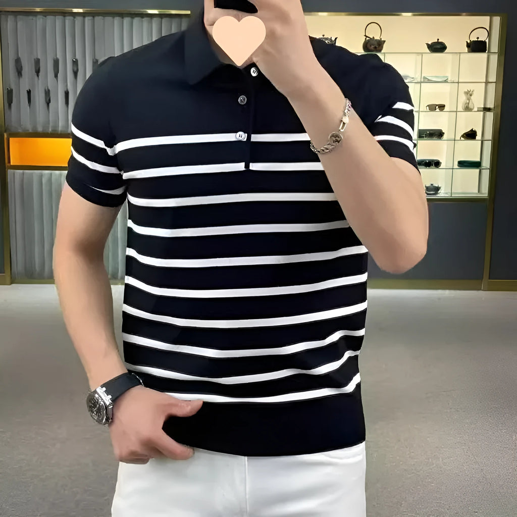 Man wearing a black and white striped knitted t-shirt with a lapel collar, showcasing a smart-casual look.