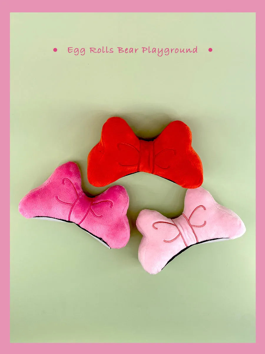 Plush bow tie helmet decoration for motorcycle and ski helmets in red, peach pink, and rose pink colours