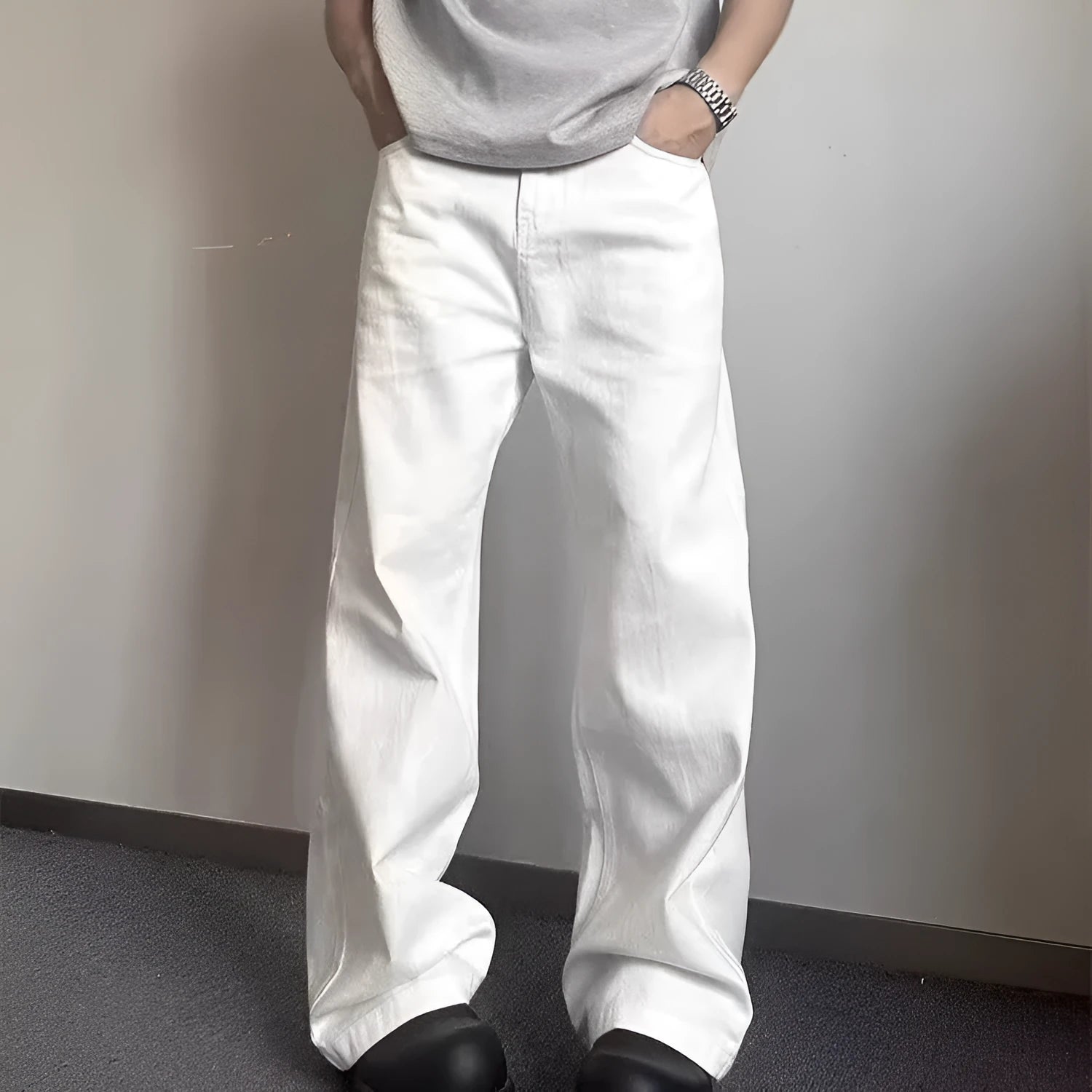 Men's white straight leg wide fit cotton denim jeans on a hanger