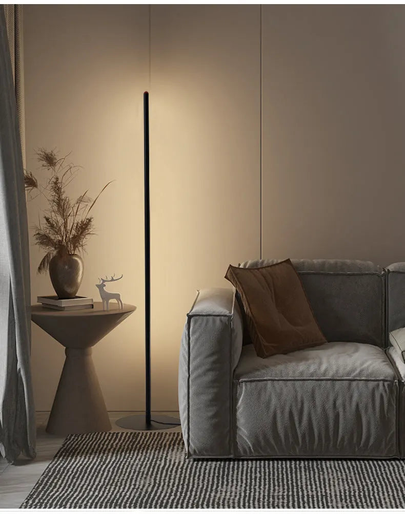 Vertical aluminium alloy floor lamp in modern simple style next to a sofa.