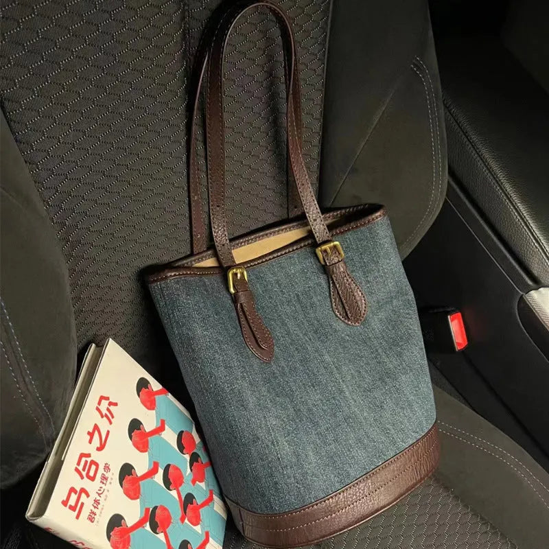 Blue denim patchwork one-shoulder bucket handbag showing retro style and large capacity.