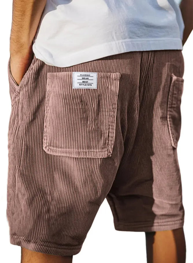 Men's grey corduroy shorts with embroidered detail on multiple pockets, laid flat.