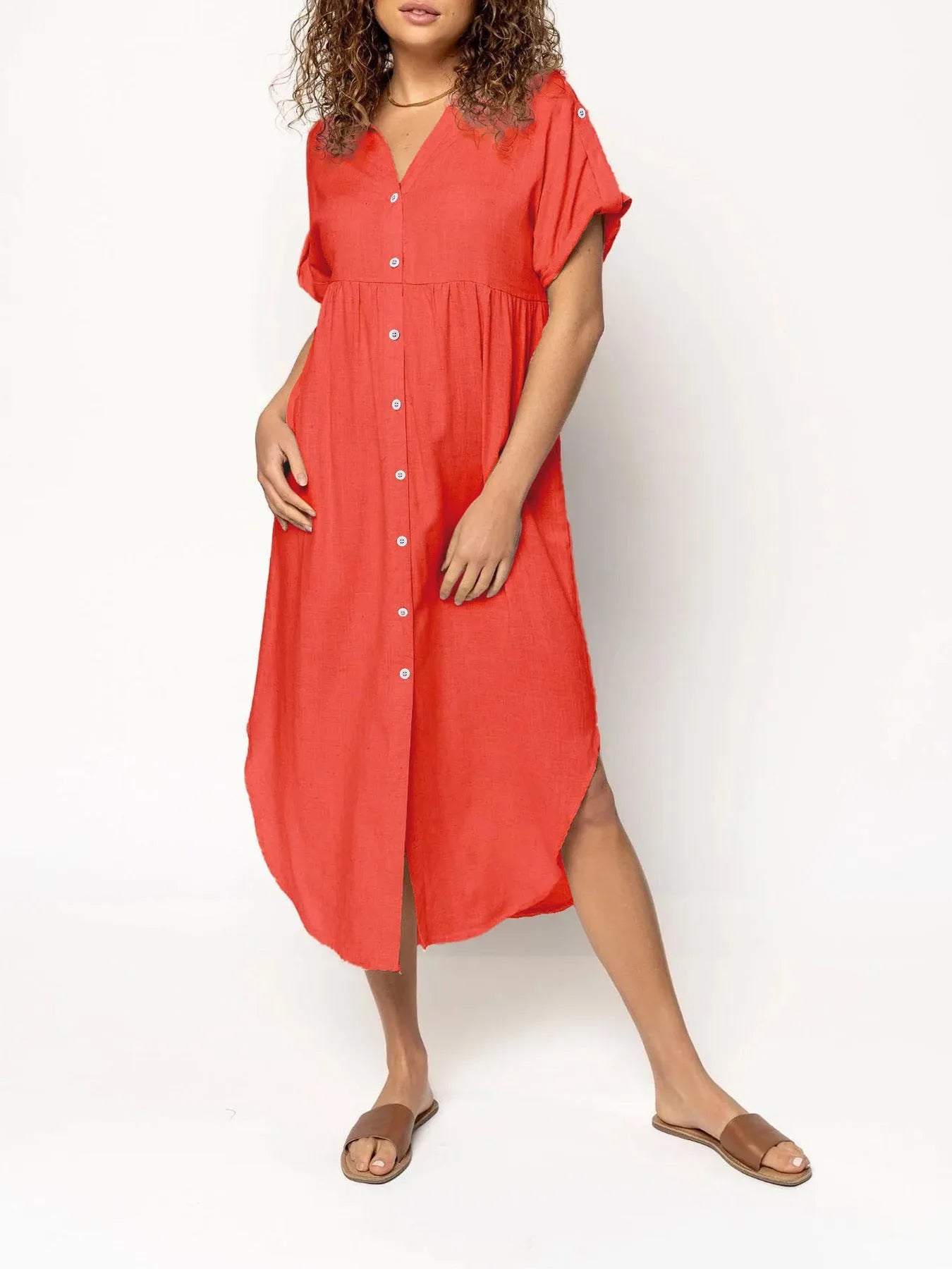 A woman wearing a casual solid-colour mid-length dress with a button-down front.