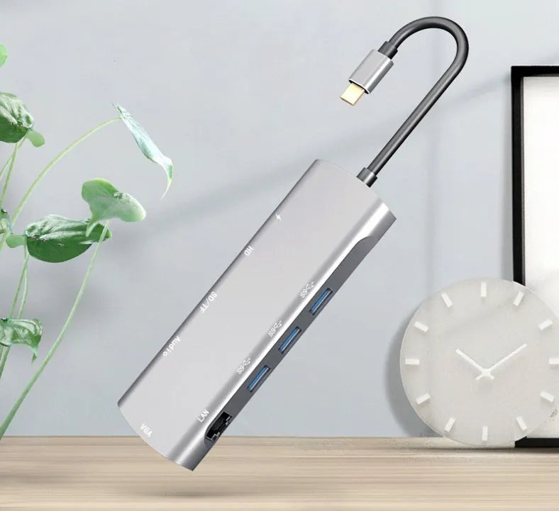 Grey USB-C docking station with HDMI, VGA, and USB 3.0 ports on aluminium alloy body