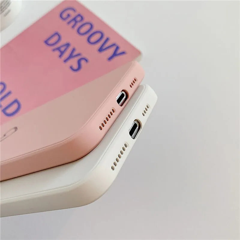 Silicone phone case for Apple iPhones in multiple solid colours including black, white, and pastel options