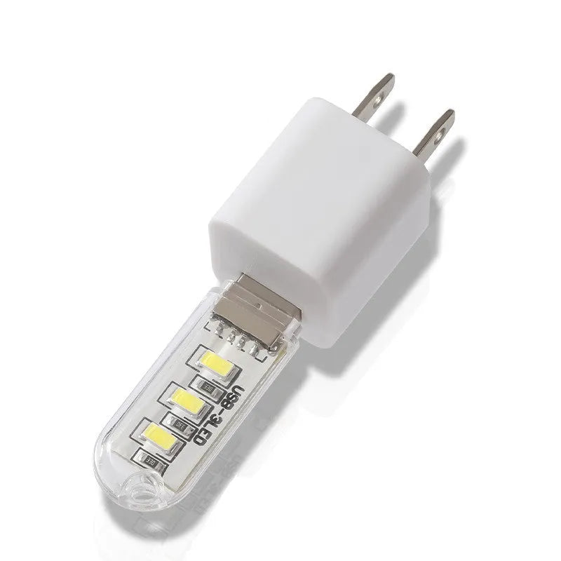 Small white USB-powered LED baby night light showing warm and cool light modes.