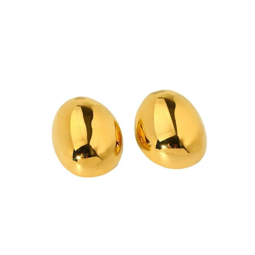 Close-up of simple geometric stainless steel stud earrings with 18K gold plated glazed finish and line design.