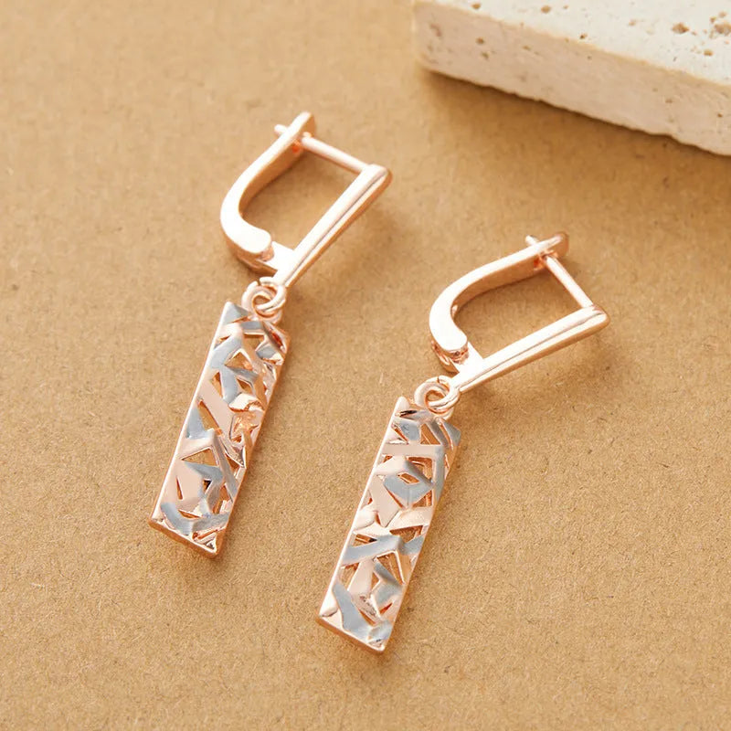 A pair of rectangular hollow geometric stud earrings with a two-tone colour finish on alloy posts.